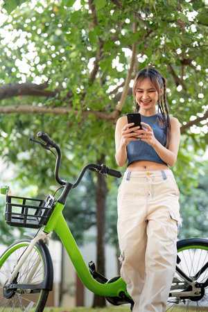 Happy young asian woman in casual clothes enjoy riding bicycle at the park for recreation