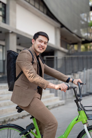 The businessman eco friendly transportation, cycling through the city avenues to go to work. sustainable lifestyle conceptの写真素材