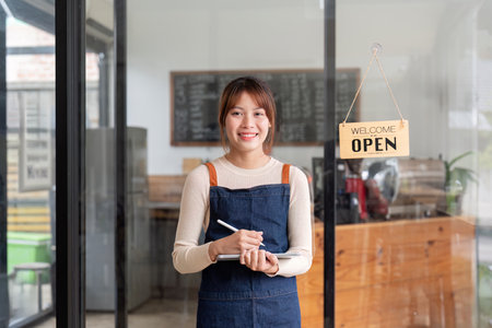 Successful small business owner young asian woman barista stand at her cafe