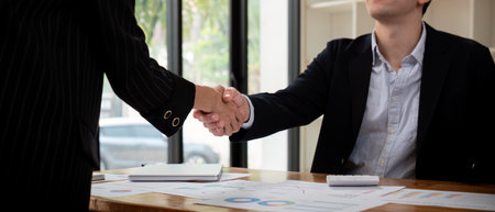 Meeting and greeting concept, Two business handshake and business people after discussing good deal...