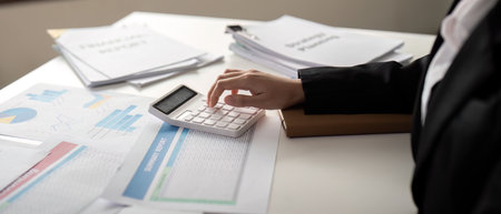 Documents, Business woman and accountant reading report for information, financial data or analysis. Paperwork, auditor check, review and bookkeeping, Calculate finance and tax in officeの写真素材