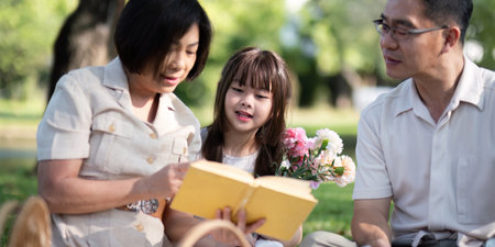 Grandparents enjoying with granddaughter in park and serenity. They are having joyful and cheerful...
