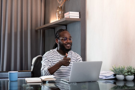 African american business afro man live online meeting on computer home. Freelance online sme marketing, young happy man video call meeting on laptop alone at homeの写真素材