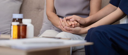 Doctor or caregiver woman holding elderly female patient hand cheer and encourage while checking healthの写真素材