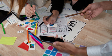 Brainstorm planning creative asian teamwork, Group of mobile phone app developer team meeting for share ideas about screen prototype layout for smartphone, ui, ux startup small businessの写真素材