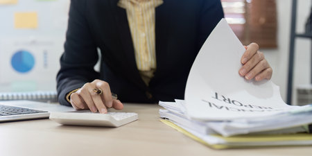 Accountant, bookkeeper using calculator to calculate financial report . account and allocating company budget.の写真素材