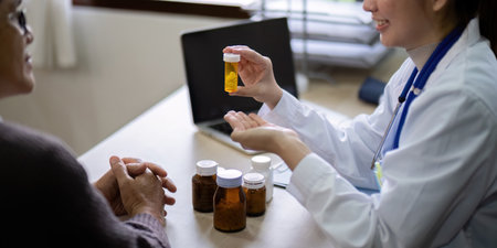 Young woman doctor sit work desk with senior old man patient prescribe drugs or pills, female nurse...