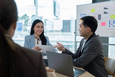 Business team in strategy discussion with documents in modern office, leadership concept