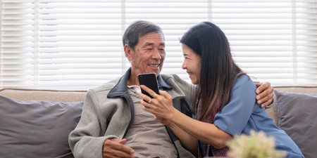 Elderly Couple Enjoying Modern Technology Together, Engaging in Phone Shopping and Social Media...