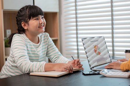 Mother and Child Working from Home Together in a Modern Home Office Setting with Laptop and...