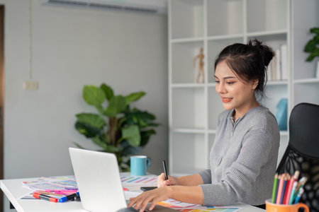 Young Woman Graphic Designer Working on Laptop in Modern Office