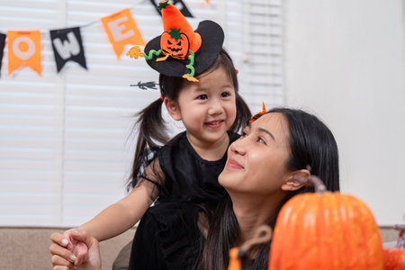 Mother and daughter enjoying Halloween decorations togetherの写真素材