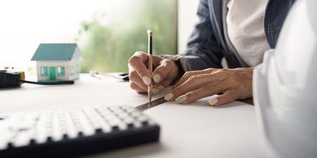 Close up of engineer drafting with pencil and ruler in officeの写真素材