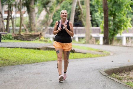 Active Elderly Woman Embracing Joyful Walking Routine in a Natural Park Setting