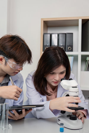 Collaborative Scientific Team Conducting Microscopic Analysis in Lab Setting