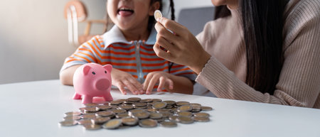 Interactive Financial Learning for Children Involving Coins and Piggy Bankの写真素材