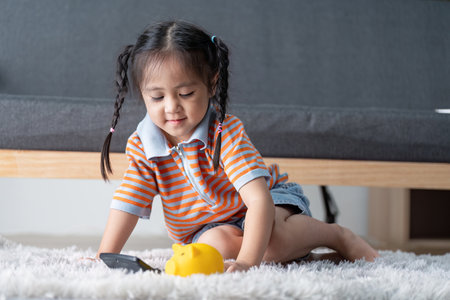 Little Girl Exploring Savings with Piggy Bank and Calculator for Financial Literacyの写真素材