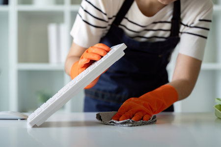 Focused Janitor Cleaning Office Keyboard with Precision and Care