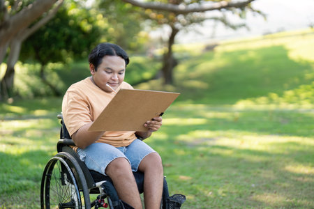 Disabled Artist Absorbing Nature for Art Inspiration on a Sunny Dayの写真素材