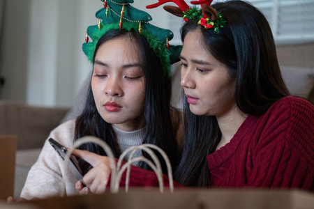Lesbian Couple Reflecting on Christmas Plans Togetherの写真素材