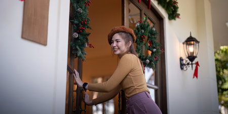 Seasonal Decor Preparer Opening Doors to Christmas Celebrationsの写真素材