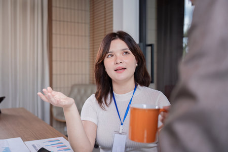 Female employee engaging with a colleague in a modern office environment