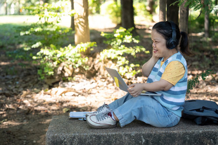 Confident Woman with Achondroplasia Enjoying Music and Technology in a Peaceful Park Setting