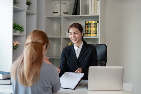 Asian Female Attorney Discussing Case with Clientの写真素材