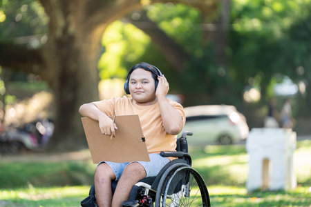 Confident Person with Disability Listening to Music Outdoorsの写真素材