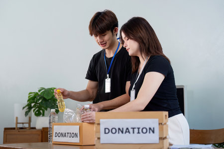 Community donation event local center volunteer activity indoor space engaging interaction supporting social causesの写真素材