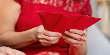 Elderly couple celebrating chinese new year home interior event festive atmosphere close-up view family traditionsの写真素材