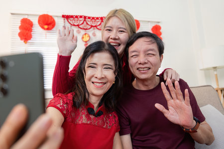 Chinese new year celebration family bonding with grandparents and granddaughter indoor setting...