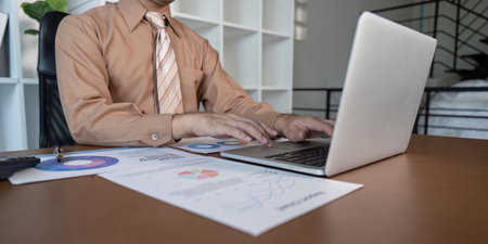 Business professional analyzing data reports office environment digital content modern workspace strategic insightsの写真素材