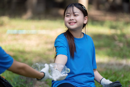 Family volunteers collect garbage in nature community engagement outdoor environment positive impactの写真素材