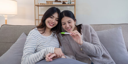 Lesbian couple celebrating ivf journey home setting emotional moment cozy environment joyful conceptの写真素材