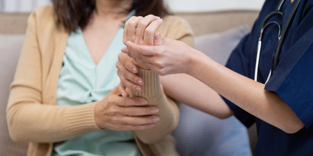 Elderly patient check up by caregiver doctor and nurse at home caring environment close up view on symptomsの写真素材