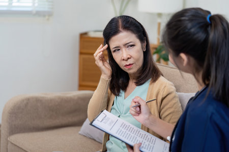 Caregiver checks symptoms of elderly patient with doctor in nursing environment close up view health assessment conceptの写真素材