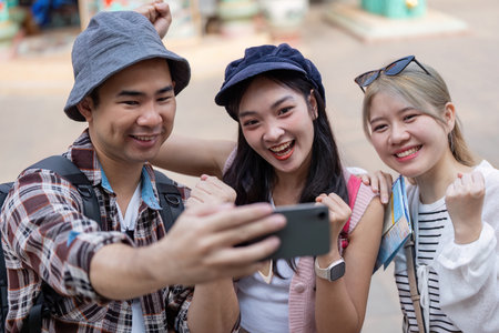 Friends capture joyful travel moments together vibrant market group selfie outdoor adventure fun spiritの写真素材