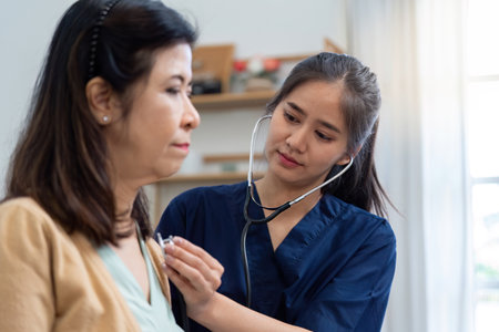 Caregiver using a stethoscope to examine elderly patient during health assessment