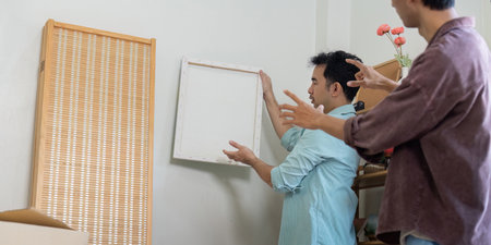 LGBTQ couple moving into a new home, discussing wall decor, and sharing ideas.