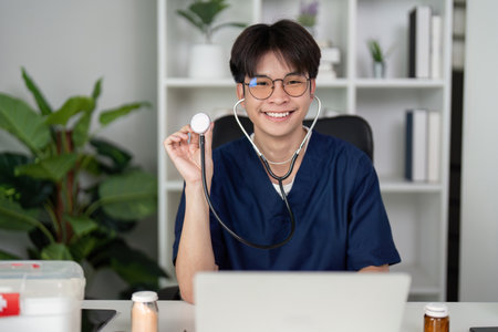 Cheerful medical student holding a stethoscope and smiling at the cameraの写真素材