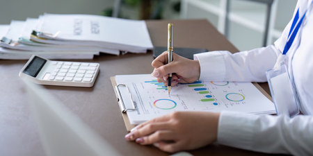 Professional accountant documenting financial data and trends with a focus on analysis and strategy.