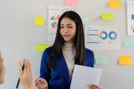Business analyst presenting budget analysis and project planning in a team meeting, discussing...