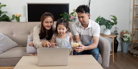 Family enjoying a movie night with snacks and laughter