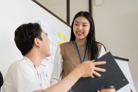 Engaged team members sharing ideas about financial planning, highlighting collaboration and positivity.の写真素材