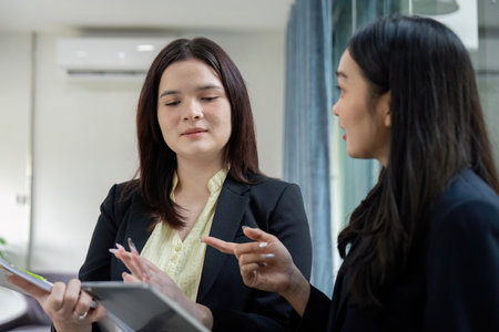 Business partners collaborating on financial planning and analysis.の写真素材