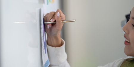 Professional writing on a whiteboard while discussing financial strategies