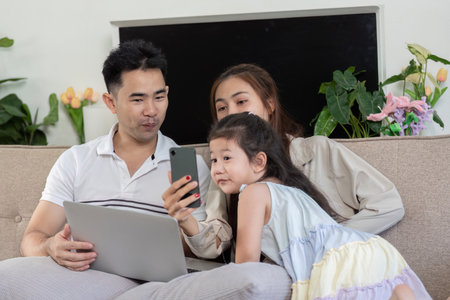 Family bonding time as they watch together.の写真素材