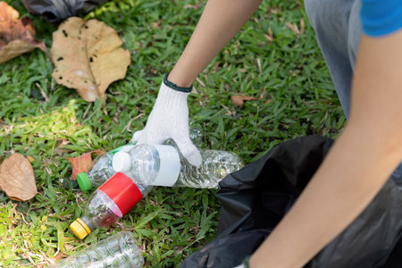 Volunteer collecting plastic bottles during an environmental cleanup