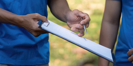 Sustainable volunteering. Close-up of volunteers preparing materials for an environmental project.の写真素材